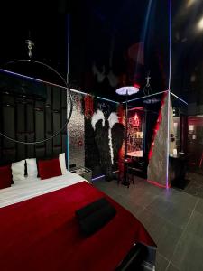 a bedroom with a large bed with a red blanket at Angels Spa & Massage by Secret Apartaments in Gdańsk