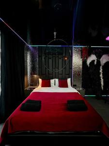 a bedroom with a large red bed with red pillows at Angels Spa & Massage by Secret Apartaments in Gdańsk