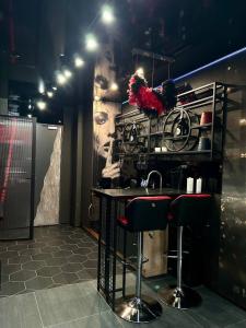 a bathroom with a counter with two bar stools at Angels Spa & Massage by Secret Apartaments in Gdańsk