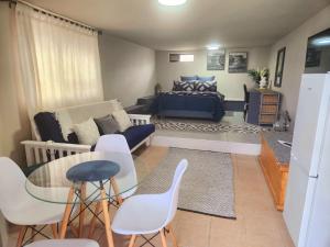 a living room with a couch and a table and chairs at VitaminSea in Mossel Bay