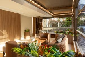a living room with furniture and plants at The Marni Hotel & Spa - Adults Only 12 Plus in Antalya