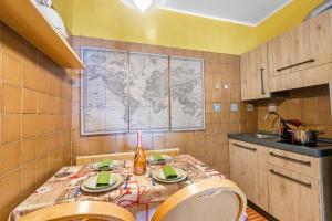 a kitchen with a table with a map on the wall at Grange Studio - Happy Rentals in Grange Sises