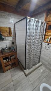 a bathroom with a shower stall and a sink at Cabañas de montaña Triskel in Aluminé +3 photos