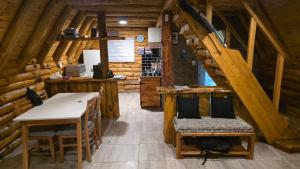 a room with a table and chairs in a cabin at Cabañas de montaña Triskel in Aluminé