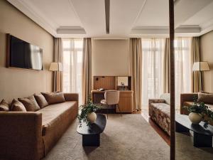 a living room with a couch and a table at Hotel Único Madrid, Small Luxury Hotels in Madrid