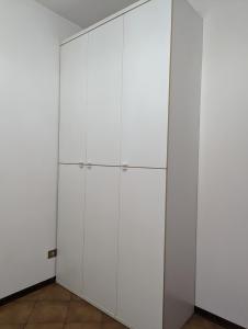 a large white cabinet in a room at Casafiorella in Monza