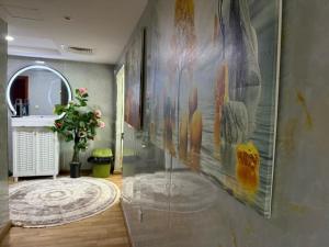 a hallway with a large painting on the wall at الهورايزون in Ajman 