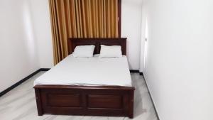 a bed with two pillows on it in a room at skymirror unawatuna in Unawatuna