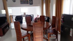 a dining room with a wooden table and chairs at skymirror unawatuna in Unawatuna