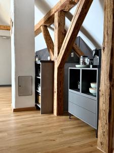 a kitchen with wooden beams and a wooden floor at Dachblick by Zirwick Apartment in Windischeschenbach