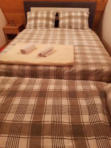 a bed with two towels on top of it at Vikendica Rujiste in Mostar