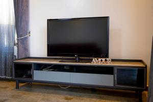 a flat screen tv sitting on top of a entertainment center at Villa d'exception Rebero in Kigali