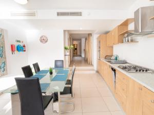a kitchen with a dining room table and chairs at Birgu Seafront 3 Bedroom Apartment in Vittoriosa +13 photos