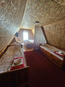 a room with two bunk beds in a attic at Kod Gruja in Ribnica