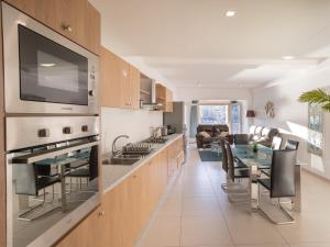 a kitchen with a table and a dining room at Birgu Seafront 3 Bedroom Apartment in Vittoriosa