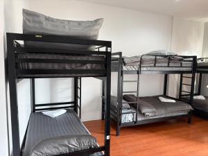 a group of bunk beds in a room at Lunar Nomad Hostel in Ban Nua
