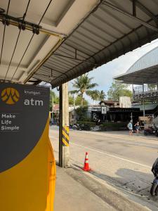 a gas station with a sign on the side of a street at Lunar Nomad Hostel in Ban Nua