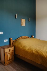 a bedroom with a bed and a blue wall at Huize Henk in Emst