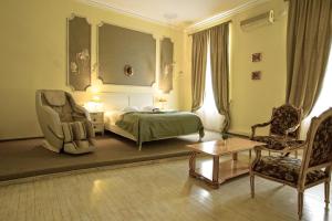 a hotel room with a bed and a chair at Villa Venus in Deva
