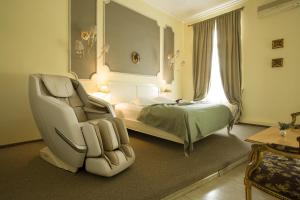 a bedroom with a chair and a bed and a window at Villa Venus in Deva