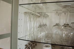 a bunch of glass vases on a glass shelf at Huize Henk in Emst +87 photos