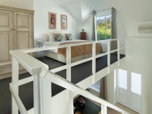 a bedroom with a bed and a staircase at La Jolie Dauphine Guest House in Franschhoek