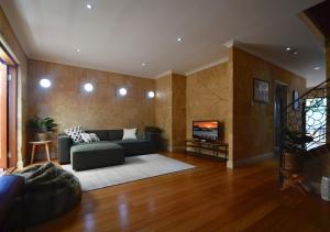 a living room with a couch and a tv at Radford Retreat in Safety Bay