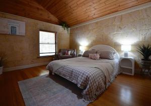 a bedroom with a bed and a chair and a window at Radford Retreat in Safety Bay