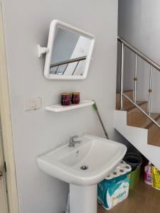 a bathroom with a sink and a mirror on the wall at Lunar Nomad Hostel in Ban Nua +14 photos