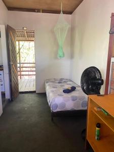 a bedroom with a bed in a room with a door at Plancton House Atins in Atins