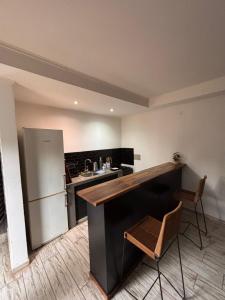 a kitchen with a counter and a refrigerator at Rincon de Tucuns in San José del Rincón