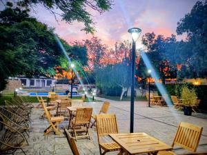 a patio with tables and chairs and a street light at Family Inn in San Rafael