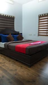 a large bed sitting in a room with at Bamboo Planet Resort in Vythiri