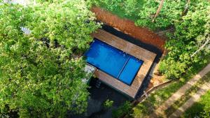 an overhead view of a swimming pool in a forest at Bamboo Planet Resort in Vythiri