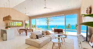 a living room with a couch and a view of the ocean at Villa Boka in Lapčići