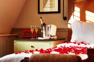 a bed with a bottle of champagne and two glasses at King Street Townhouse Hotel & Spa in Manchester