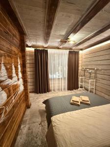 a bedroom with a bed and a wooden wall at Zrub House in Slavske +74 photos