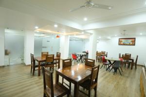 a dining room with wooden tables and chairs at CORPORATE STAYS-Golf Course Road in Gurgaon