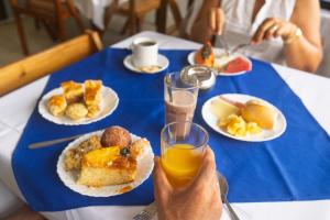 a person taking a picture of a table of breakfast foods at Brisa do Mar Praia Hotel in Morro de São Paulo +48 photos