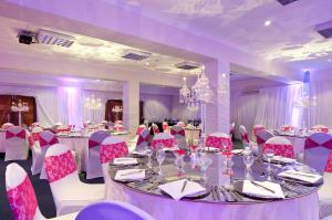 a room with a long table and pink chairs at The Kelway Hotel in Port Elizabeth +107 photos