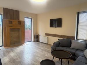 a living room with a couch and a tv at Apartment Natali Inn in Tbilisi City