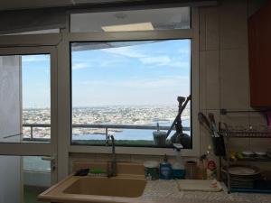 a kitchen window with a view of a city at الهورايزون in Ajman  +29 photos