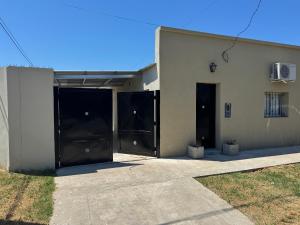 a building with two large black doors on it at Ms3M casa in San Pedro