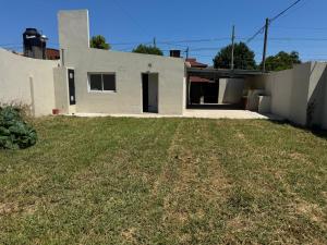 a white house with a yard in front of it at Ms3M casa in San Pedro