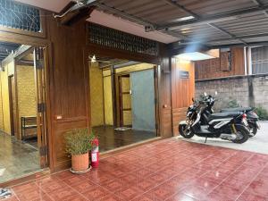 a motorcycle parked in a room with a building at TEAK HOUSE In TOWN in Mae Hong Son