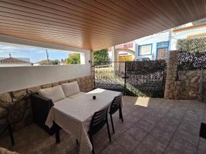 a patio with a table and chairs and a couch at Apartment Studio Espiche near Praia da Luz in Luz