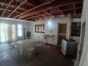 a room with a table and chairs and a television at 12 Bologna B&B in Evander +8 photos