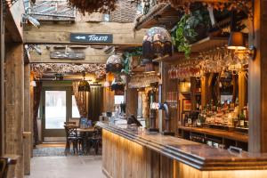 a bar in a restaurant with tables and chairs at The Bamburgh Castle Inn - The Inn Collection Group in Seahouses