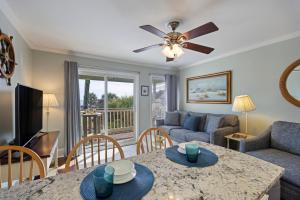 a living room with a table and a couch at SC217A: 217A Sea Cabin in Isle of Palms