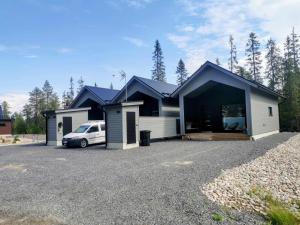 a house with a car parked in front of it at Villa Anilia in Syöte